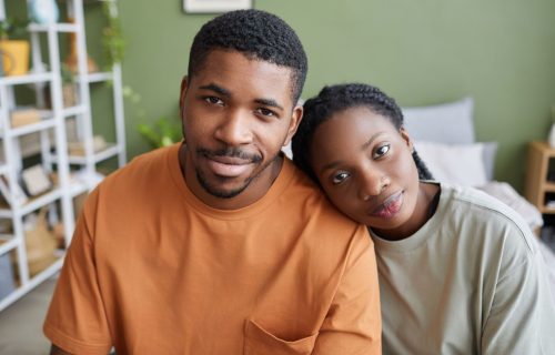 african-american-young-couple-sitting-in-bedroom-2023-11-27-05-23-23-utc