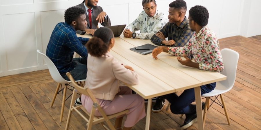 team-young-african-people-working-office-table-with-laptop_219728-2286